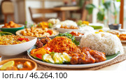 Nasi campur, indonesian rice dish with various side dishes, displayed on table. Стоковое AI-изображение, AI-художник Юрий Поздников / Фотобанк Лори