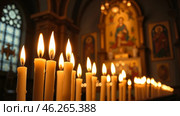 Burning church candles with holy light with a spiritual mood on the background of a religious icon. Стоковое AI-изображение, AI-художник Виталий Самсонов / Фотобанк Лори