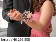 Young man and his prom date with corsage holding hands, closeup. Стоковое фото, фотограф Pixel_shot / Фотобанк Лори