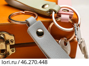 Keys with leather keychains on wooden box, closeup. Стоковое фото, фотограф Pixel_shot / Фотобанк Лори