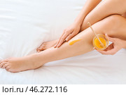Beautiful young woman with sugaring paste epilating legs at home. Стоковое фото, фотограф Pixel_shot / Фотобанк Лори