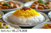 Appetizingly presented rice, divided into two colors: white and yellow. The yellow rice is decorated with bright additives - herbs and spices, which gives the dish a festive and colorful look. The rice is presented in the form of a pyramid on a white plate with a metal rim, which adds elegance and style. Around in the background, you can see other dishes, such as chicken or vegetables, which complement the overall context of the meal. This type of rice presentation is often found in traditional Eastern or Persian cuisines. Стоковое AI-изображение, AI-художник Анна Кривицкая / Фотобанк Лори