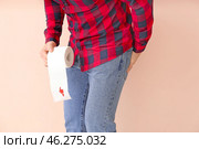Young man holding toilet paper with blood spot on color background. Hemorrhoids concept. Стоковое фото, фотограф Pixel_shot / Фотобанк Лори