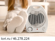 Electric fan heater and woman in warm socks on floor at home, closeup. Стоковое фото, фотограф Pixel_shot / Фотобанк Лори