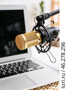 Modern laptop on table and stand with professional microphone in light room, closeup. Стоковое фото, фотограф Pixel_shot / Фотобанк Лори