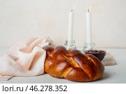 Traditional challah bread with glowing candles on white background. Shabbat Shalom. Стоковое фото, фотограф Pixel_shot / Фотобанк Лори