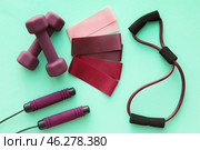 Elastic bands, dumbbells, skipping rope and fitness expander on color background. Стоковое фото, фотограф Pixel_shot / Фотобанк Лори