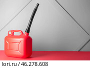 Plastic jerrycan on grey background. Стоковое фото, фотограф Pixel_shot / Фотобанк Лори