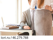 Boss molesting his secretary in office. Стоковое фото, фотограф Pixel_shot / Фотобанк Лори