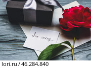 Gift box and letter with text I'M SORRY on wooden background. Стоковое фото, фотограф Pixel_shot / Фотобанк Лори
