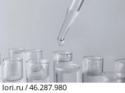 Pipette dripping sample into test tube on light background, closeup. Стоковое фото, фотограф Pixel_shot / Фотобанк Лори