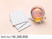 Drink coasters with cup of tea on beige table. Стоковое фото, фотограф Pixel_shot / Фотобанк Лори