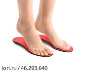 Female feet and red orthopedic insoles on white background. Стоковое фото, фотограф Pixel_shot / Фотобанк Лори