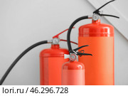 Fire extinguishers on grey background. Стоковое фото, фотограф Pixel_shot / Фотобанк Лори