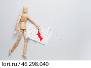 Wooden human figure, suppository and toilet paper with blood spot on light background. Hemorrhoids concept. Стоковое фото, фотограф Pixel_shot / Фотобанк Лори