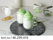 Board with cups of tasty dalgona matcha latte on light background. Стоковое фото, фотограф Pixel_shot / Фотобанк Лори