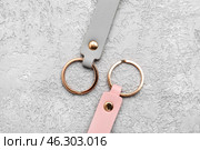 Leather keychains on grey background. Стоковое фото, фотограф Pixel_shot / Фотобанк Лори