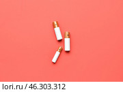 Alkaline batteries on red background, top view. Стоковое фото, фотограф Pixel_shot / Фотобанк Лори