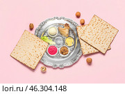 Passover Seder plate with traditional food on color background, top view. Стоковое фото, фотограф Pixel_shot / Фотобанк Лори