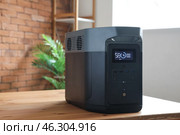 Portable power station on table in living room. Стоковое фото, фотограф Pixel_shot / Фотобанк Лори