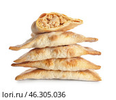 Stack of baked meat empanadas on white background. Стоковое фото, фотограф Pixel_shot / Фотобанк Лори