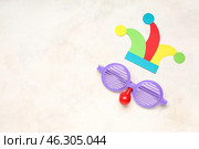 Funny disguise with paper fool's hat on white background. Стоковое фото, фотограф Pixel_shot / Фотобанк Лори