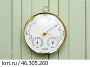 Aneroid barometer on green wooden background. Стоковое фото, фотограф Pixel_shot / Фотобанк Лори