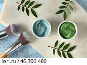 Bowls with cosmetic clays and brushes on color background. Стоковое фото, фотограф Pixel_shot / Фотобанк Лори