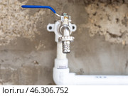 Iron faucet on a propylene pipe, water supply in the garden outdoors. Стоковое фото, фотограф Коханова Наталья / Фотобанк Лори