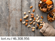 Various tasty nuts and dried fruits on wooden table. Стоковое фото, фотограф Pixel_shot / Фотобанк Лори