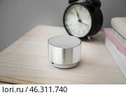 Smart home assistant device and clock on table against grey background. Стоковое фото, фотограф Pixel_shot / Фотобанк Лори