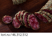 Sliced spanish sausage fuet with herbs. Стоковое фото, фотограф Яков Филимонов / Фотобанк Лори