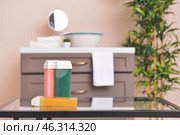 Liposoluble wax cartridges on table in bathroom. Стоковое фото, фотограф Pixel_shot / Фотобанк Лори