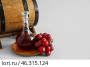 Decanter of wine with barrel on grey background. Стоковое фото, фотограф Pixel_shot / Фотобанк Лори