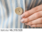 Woman buttoning up striped shirt, closeup. Стоковое фото, фотограф Pixel_shot / Фотобанк Лори