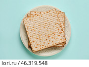 Plate with Jewish flatbread for Passover on color background. Стоковое фото, фотограф Pixel_shot / Фотобанк Лори