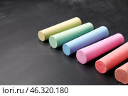 Colorful chalks on blackboard, closeup. Стоковое фото, фотограф Pixel_shot / Фотобанк Лори