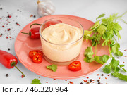 Glass of tasty chipotle sauce and spices on light background. Стоковое фото, фотограф Pixel_shot / Фотобанк Лори