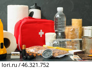 Necessities for emergency bag on dark table. Стоковое фото, фотограф Pixel_shot / Фотобанк Лори