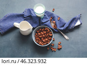 Bowl with chocolate cornflakes and jug of milk on dark background. Стоковое фото, фотограф Pixel_shot / Фотобанк Лори