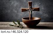 Religion, faith, liturgy, Ash Wednesday. Great lent. A wooden cross, a ceremonial bowl made of ash and an olive branch on a gray background. Стоковое AI-изображение, AI-художник Photojuli / Фотобанк Лори