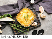Baking dish with tasty julienne and ingredients on grey background. Стоковое фото, фотограф Pixel_shot / Фотобанк Лори