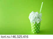 Cup with tasty cotton candy on color background. Стоковое фото, фотограф Pixel_shot / Фотобанк Лори