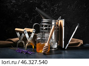 Beekeeping supplies and honey on dark background. Стоковое фото, фотограф Pixel_shot / Фотобанк Лори