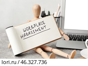 Mannequin with text WORKPLACE HARASSMENT on table. Стоковое фото, фотограф Pixel_shot / Фотобанк Лори