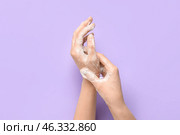 Woman washing hands with soap on purple background. Стоковое фото, фотограф Pixel_shot / Фотобанк Лори