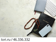 Holy Bible, PC keyboard and mobile phone on light background. Стоковое фото, фотограф Pixel_shot / Фотобанк Лори