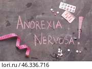 Measuring tape and pills with text ANOREXIA NERVOSA on grunge background. Стоковое фото, фотограф Pixel_shot / Фотобанк Лори