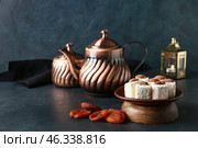 Tasty Turkish delight with dried apricots and tea on dark background. Стоковое фото, фотограф Pixel_shot / Фотобанк Лори