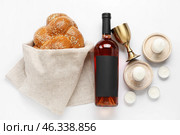 Traditional challah bread with wine and candles on white background. Shabbat Shalom. Стоковое фото, фотограф Pixel_shot / Фотобанк Лори